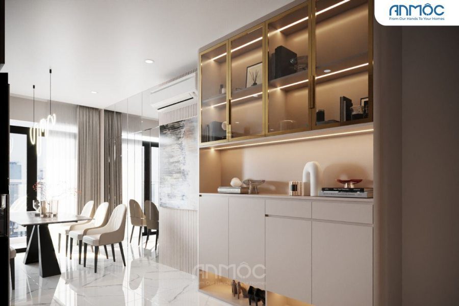 Góc nhìn từ cửa vào, tủ đựng đồ màu be và vàng kim, kết hợp kệ trang trí và hệ thống đèn led chiếu sáng, thể hiện sự sang trọng