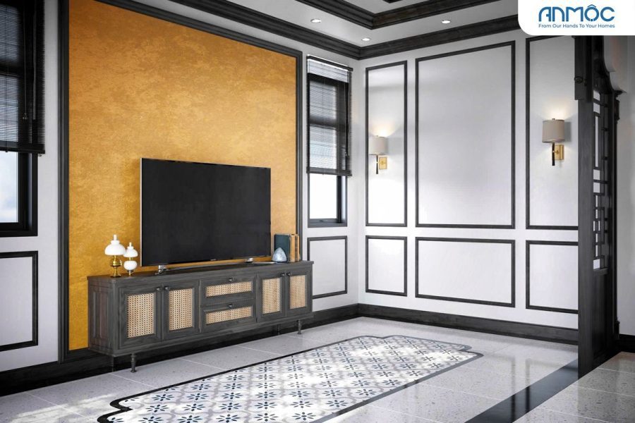 Cận cảnh kệ TV phong cách indochine với chi tiết mây đan, kết hợp tường vàng ấn tượng và gạch lát sàn họa tiết, tạo nên sự kết hợp hài hòa.