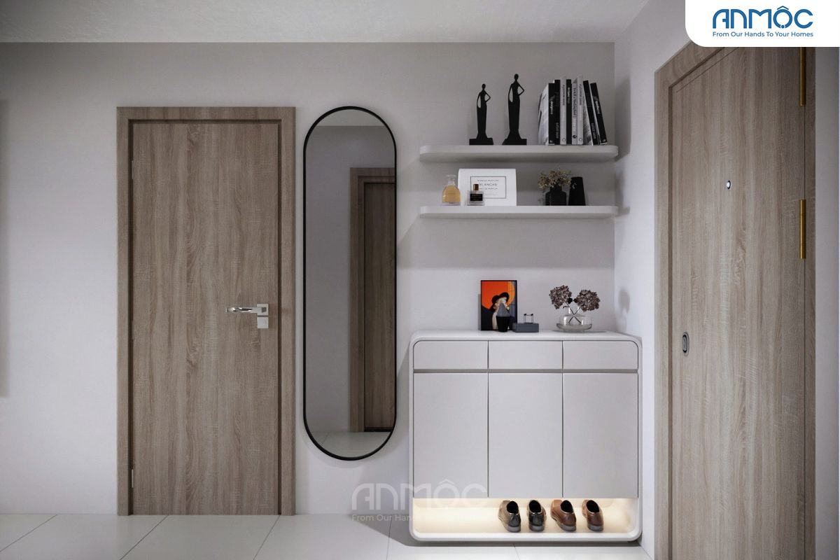 Khu vực sảnh được thiết kế với tủ giày trắng, gương đứng, và kệ tường trang trí