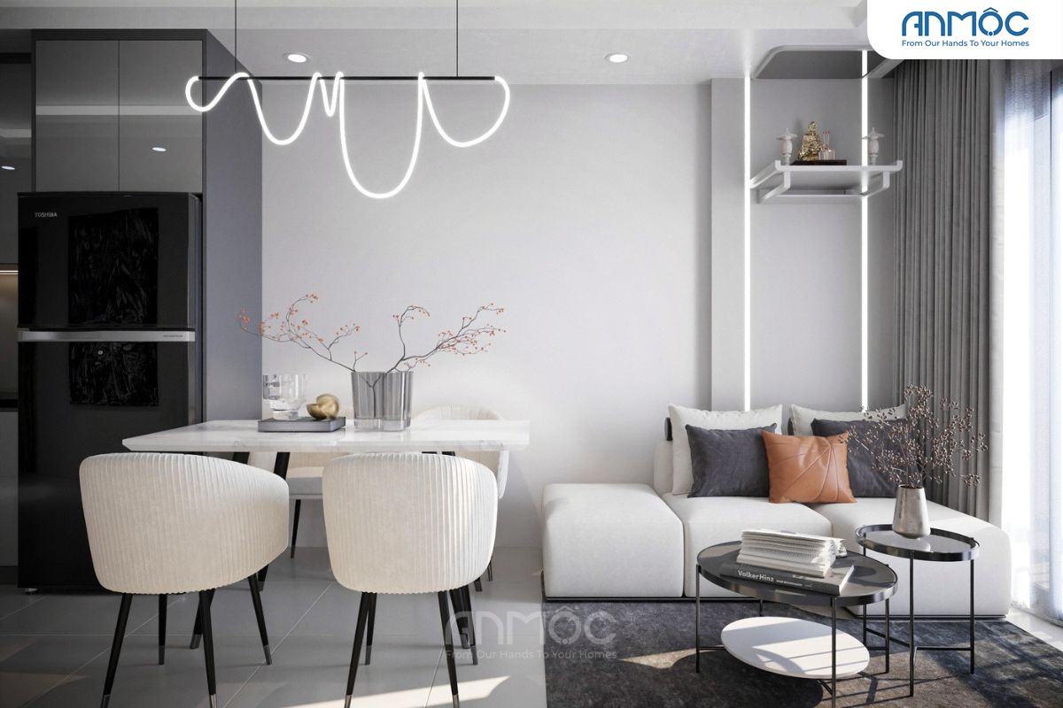 Khu vực phòng ăn và khách liền kề, đèn trần độc đáo, bàn ăn trắng thanh lịch cùng sofa êm ái