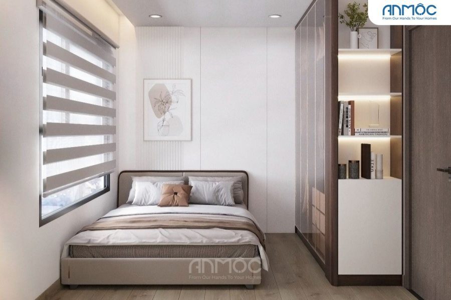Phòng ngủ 2 gọn gàng với giường nhỏ, tranh treo tường trừu tượng màu be và đèn gắn tường hiện đại