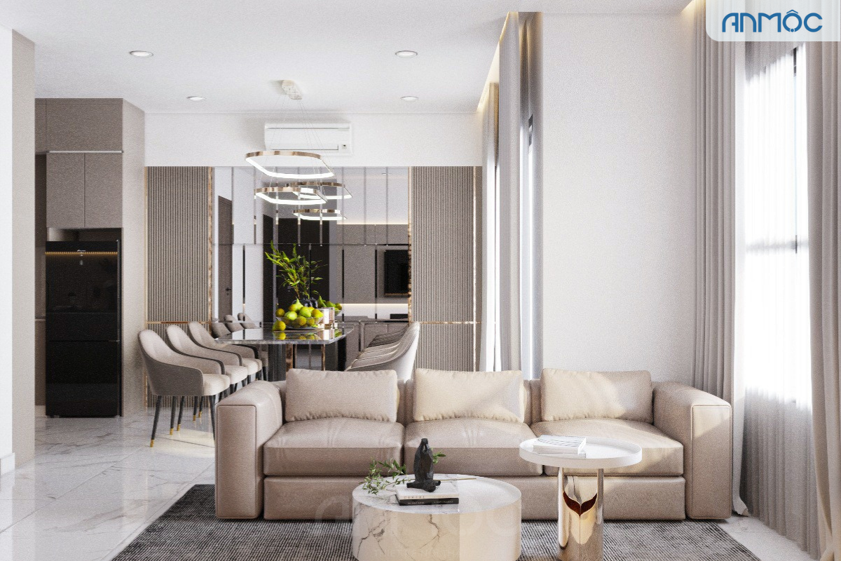 Góc phòng khách với kệ TV treo tường màu be, hệ đèn hắt sáng và rèm cửa màu kem tạo cảm giác ấm cúng